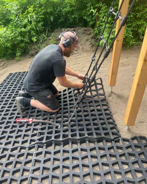 Filling of the hollow playground safety rubber mats with washed sand/gravel